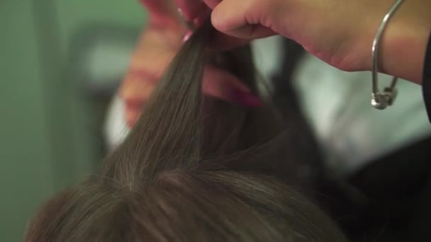 Hair stylist hands close up creates hairstyle hairdresser spreads the models hair starting hairstyle creation — Stock Video