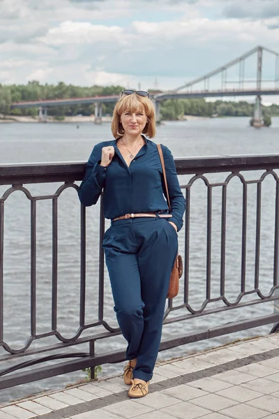 Middle-aged woman portrait standing on the riverbank Royalty Free Stock Images