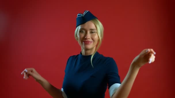 De stewardess glimlacht lief en dansen op camera — Stockvideo
