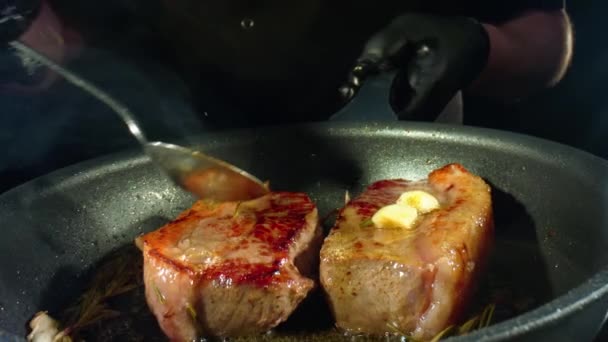 Roasting steaks on frying pan at kitchen, closeup view of cooking process. Shot on Laowa Macro Probe — Stock Video