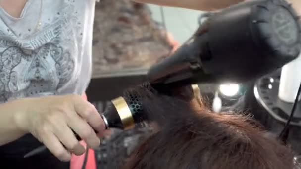 Hairdresser Stylist Using Comb Hair Dryer Dries Makes Brunette Girl — Stock Video