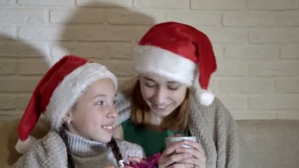 Portrait Two Girls Santa Claus Hats Covered Blanket Sit Couch — Stock Video