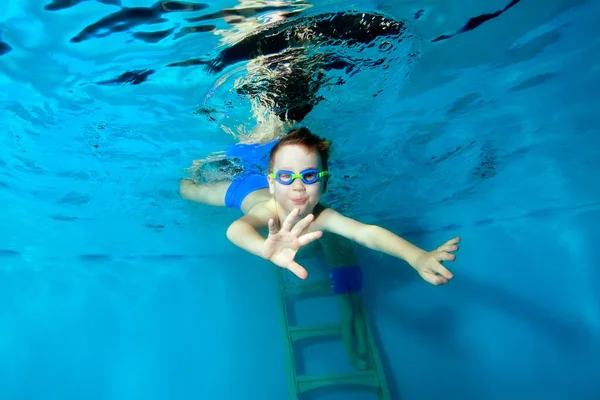 스포티 한 어린 소년은 수영장의 바닥에 다이빙, 팔을 뻗어. 초상화. 닫아. 수중 사진. 수평 방향 — 스톡 사진