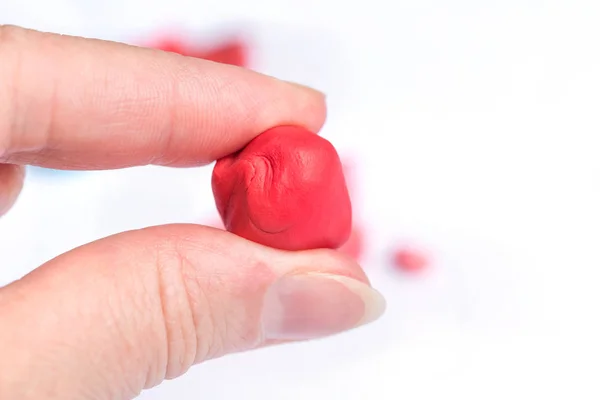 Una Bola Roja Plastilina Mano Mujer —  Fotos de Stock