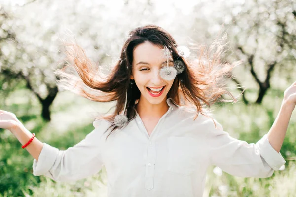 portrait of tender woman in spring blooming garden