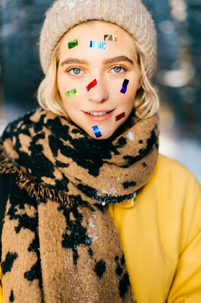 portrait of beautiful woman with scarf in winter forest