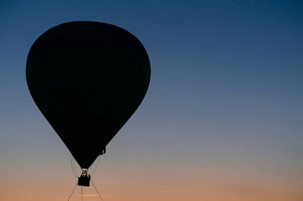 air balloon flying up in sky during beautiful sunset