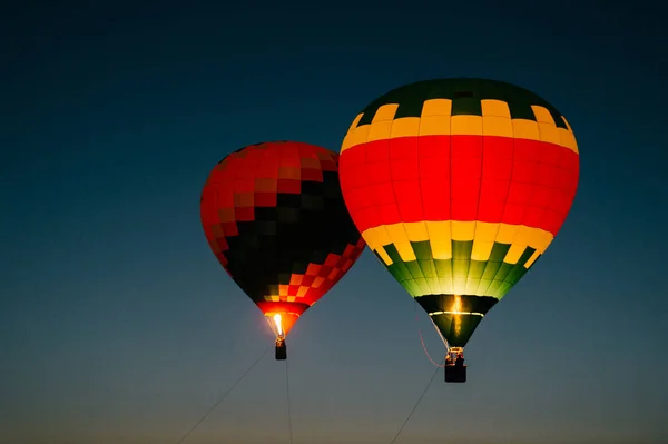 air balloons flying up in sky during beautiful sunset