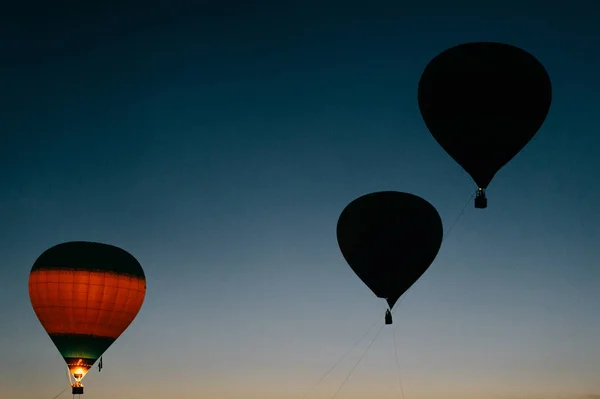 air balloons flying up in sky during beautiful sunset