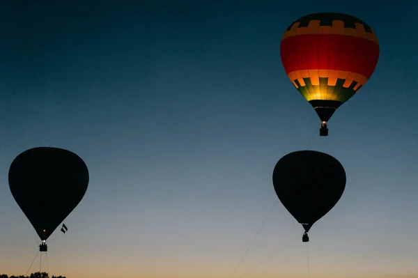 air balloons flying up in sky during beautiful sunset