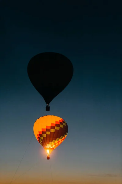 air balloons flying up in sky during beautiful sunset