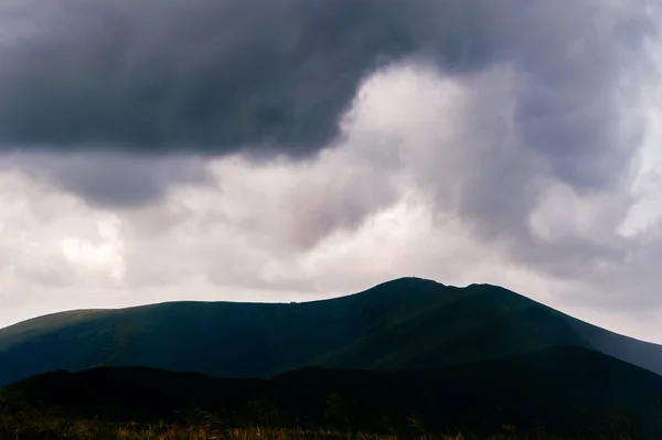 stock image scenic view of storm rainy clouds over mountain hills