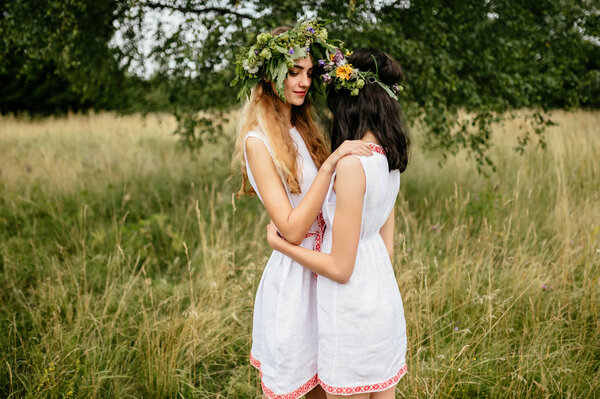 young beautiful women in ethnic clothes in summer field