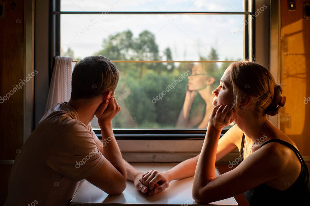 romantic couple of lovers travelling by train