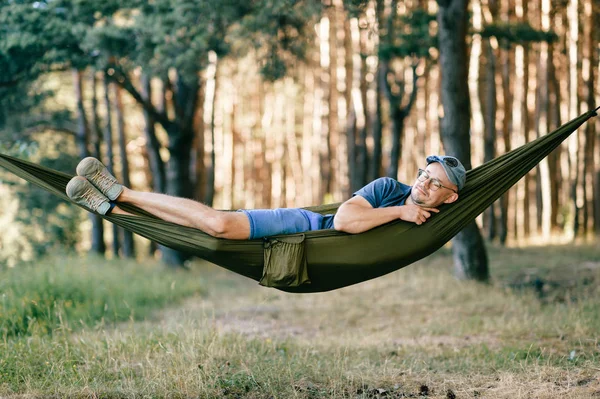 traveller resting in hammock on summer day