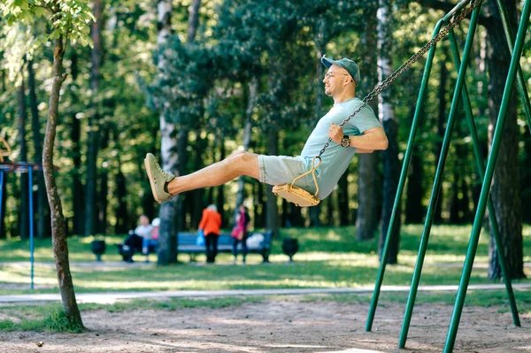 Adult Man Swinging Swing Playground Summer Park — Stock Photo, Image