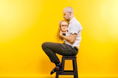 kel adam Sarı zemin tahta sandalyede otururken plastik manken kafa tutan