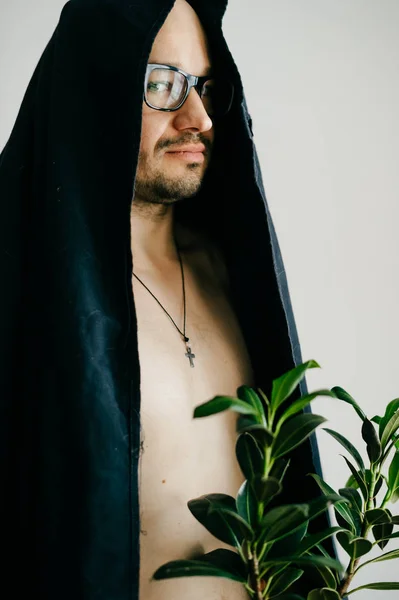 Muž Brýlích Černou Slavnostní Plášť Drží Hrnec Zelených Rostlin — Stock fotografie