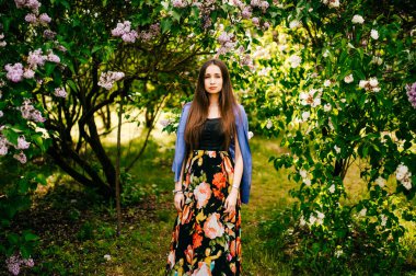 Genç güzel kadın yaz çiçek açan bahçesinde