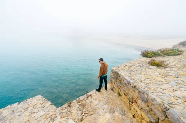 tourist standing near sea in Peniche in Portugal