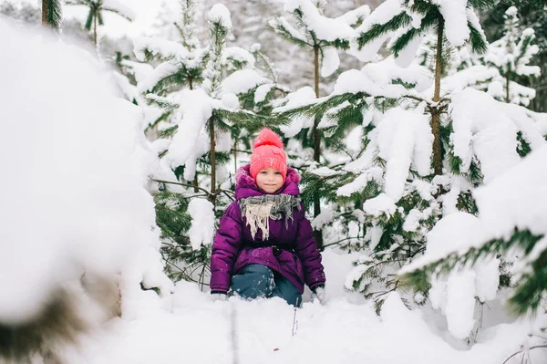 冬の雪の森の小さな女の子のポーズ — ストック写真