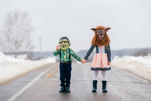 obscured view of children in creepy masks outdoors