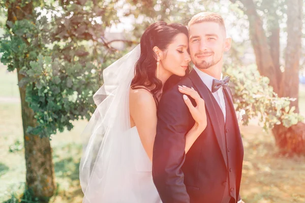 romantic bride and groom posing outdoors - Stock Image - Everypixel Romantic Bride And Groom Posing Outdoors - Stock Image - Everypixel