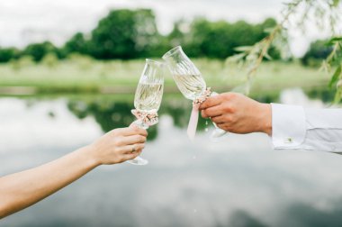 Gelin ve damat gözlük şampanya ile tutarak kısmi görünümünü