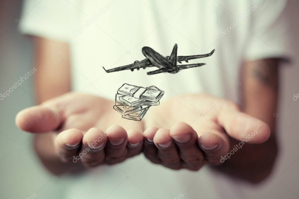businessman holding a plane and money