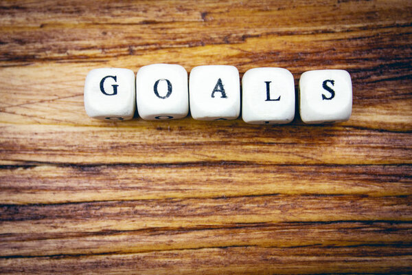 слова цели, написанные деревянными буквами
