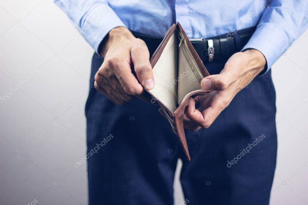 young man holding empty wallet