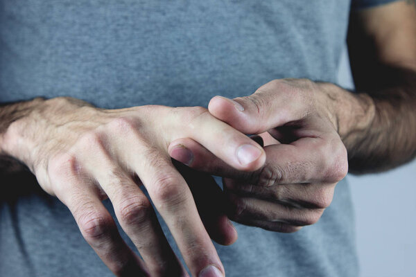 A man is holding his aching hand