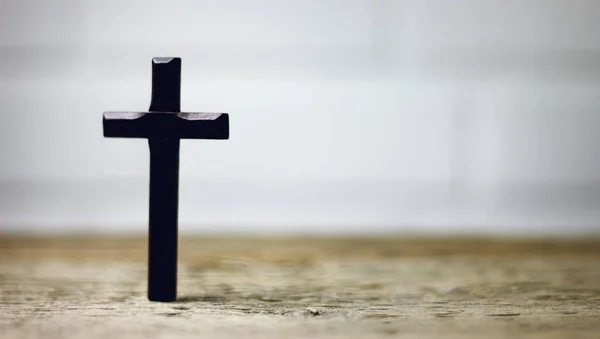 wooden cross on wooden table