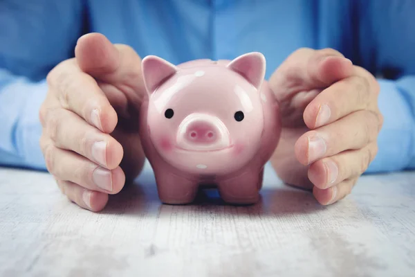 Man holding a piggy bank — Stock Photo, Image