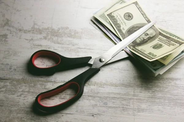 Dollar banknotes with scissors lying — Stock Photo, Image
