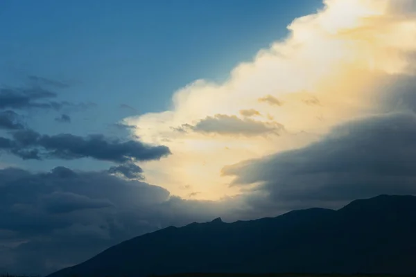 Dark sky and a sharp black cloud before the rain.