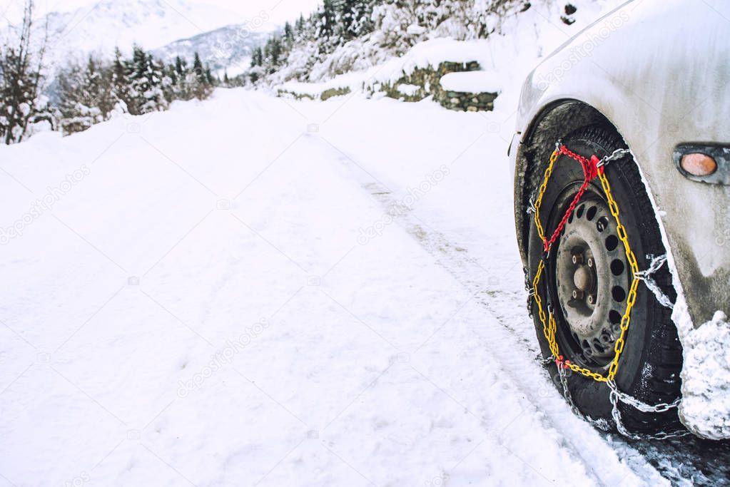 Car with mounted snow chains in wintry environment