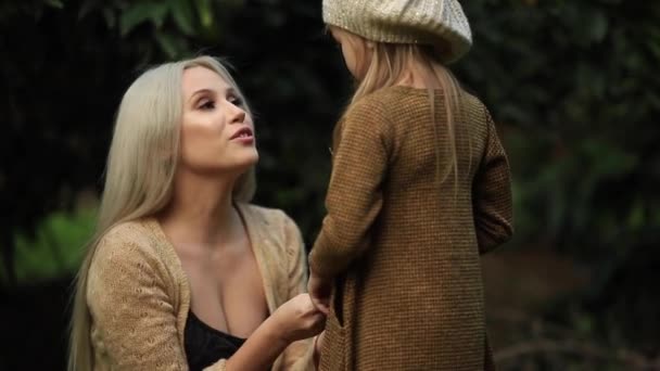 Family values: Family spends time in nature. mother tenderly embracing daughter, beautiful mom playing with her children in the park — Stock Video