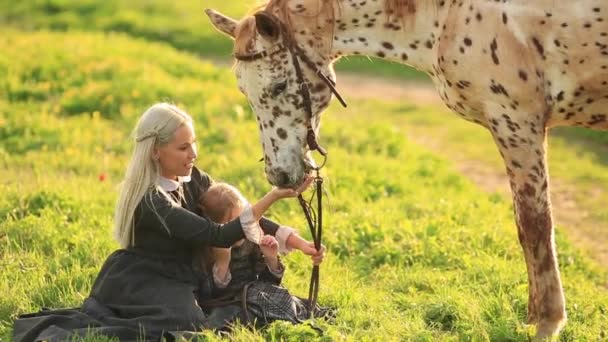 Beautiful woman and girl embracing horse. slow motion full hd — Stock Video