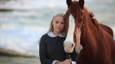 the woman hugs brown on the background of the sea