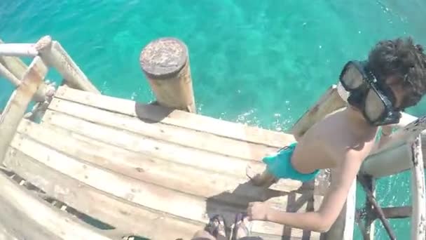 Άθλημα άλμα αγόρι κάνει flip σε θαλασσινό γαλάζιο νερό, αργή κίνηση — Αρχείο Βίντεο