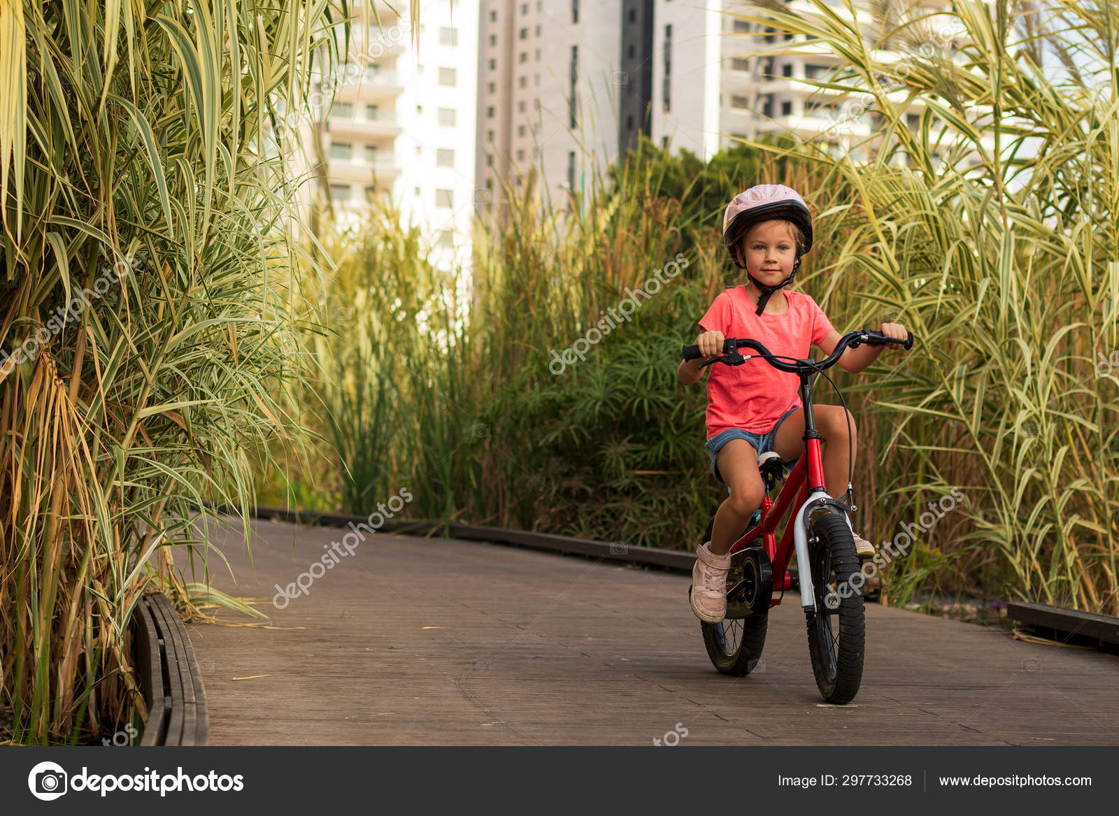 Happy child rides a bike on bike Cyclist child girl enjoys