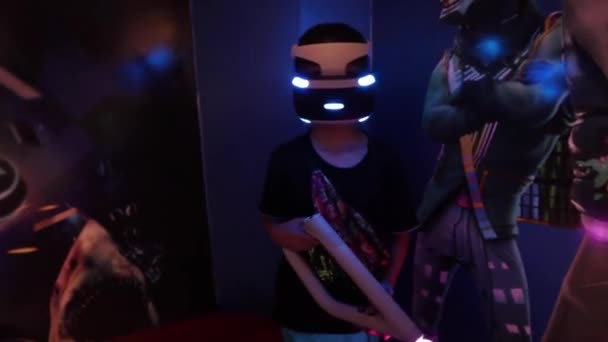 Boy in VR glasses of virtual reality playing game. Virtual augmented reality helmet — Wideo stockowe