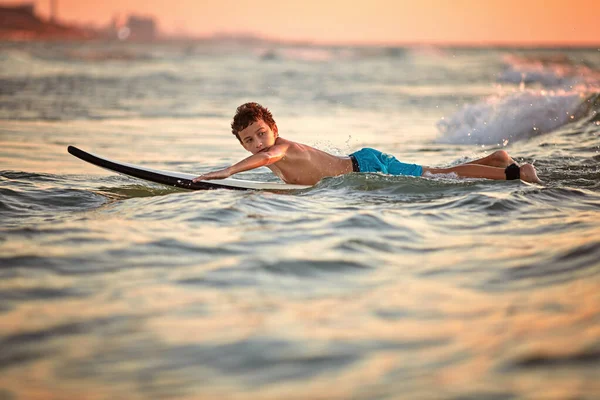 일몰에 서핑. 젊은 남자는 일몰에서 파도 타고. 활동적인 야외 생활 — 스톡 사진