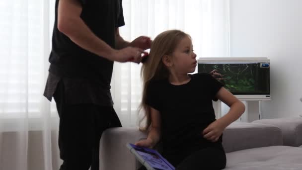 Porträtt av pappa hjälpa sin dotter att kamma håret hemma — Stockvideo