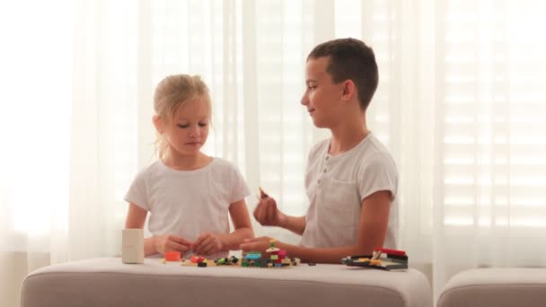 Conflict between a boy and a girl. the kids are fighting, the boy takes the girls toy — Stock Video