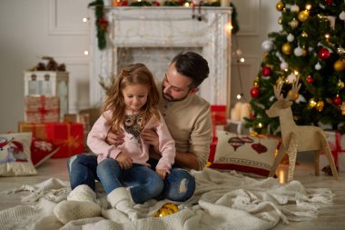 Christmas giving gifts concept. Young family having fun at Christmas eve