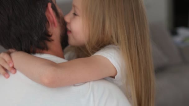 Fathers daughter. little girl blue eyes and blonde hair hugs dad close up — Stock Video