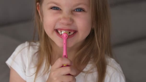 小さな女の子ブラッシング彼女の歯に歯ブラシでバスルームで朝. — ストック動画