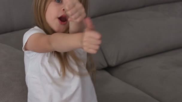 Beautiful little girl shows finger as sign that everything is fine — Stock Video